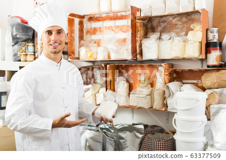Portrait of male cook standing with groats Portrait of male cook standing with groats 63377509