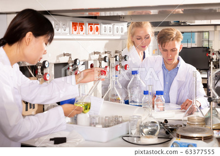 Group of scientists working together 63377555