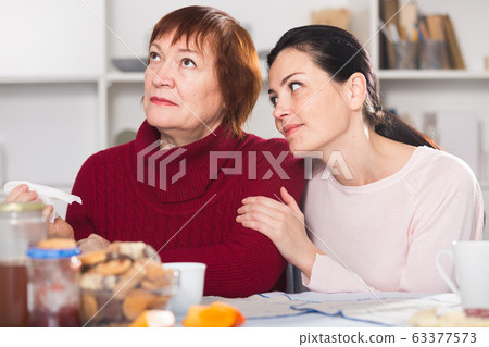 Upset mature woman quarrel with daughter sitting Upset mature woman quarrel with daughter sitting 63377573