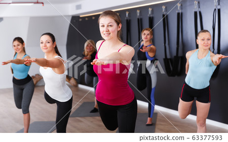 Females exercising during yoga class Females exercising during yoga class 63377593
