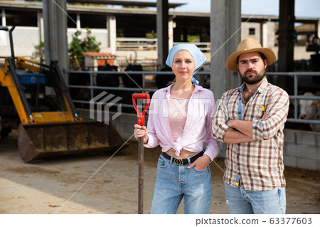 Farm family near farming equipment 63377603