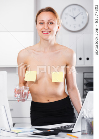 Woman with stickers on bare chest Woman with stickers on bare chest 63377802