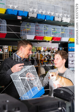 Adult man with son and dog buying pet supplies Adult man with son and dog buying pet supplies 63377879