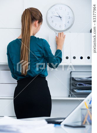 Back view of businesswoman at office interior 63377964