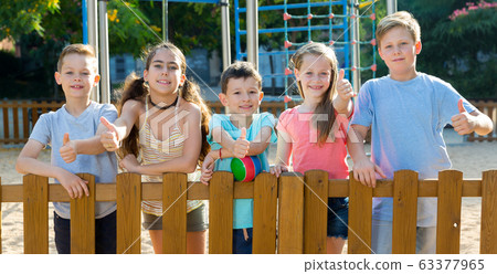Children posing at the playground and thumbs up Children posing at the playground and thumbs up 63377965
