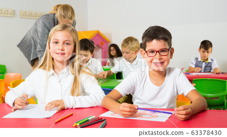 Happy pupils working in classroom 63378430