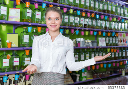 Saleswoman welcoming in perfume store Saleswoman welcoming in perfume store 63378883