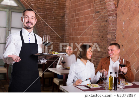 happy man waiter demonstrating country restaurant happy man waiter demonstrating country restaurant 63378887