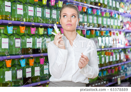 Girl choosing perfume Girl choosing perfume 63378889