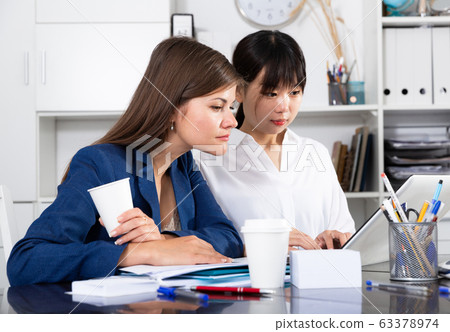 Two businesswomen working with computer in office 63378974