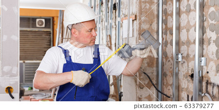 Plumber preparing plastic pipes for installation Plumber preparing plastic pipes for installation 63379277