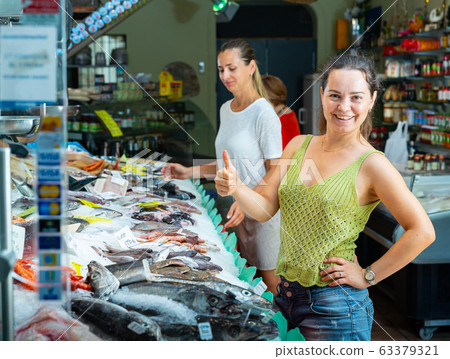 Satisfied female customer at fish shop Satisfied female customer at fish shop 63379321