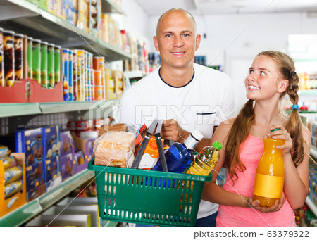 Family with shopping basket in grocery Family with shopping basket in grocery 63379322