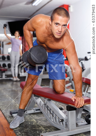 Man with naked body doing exercises Man with naked body doing exercises 63379483