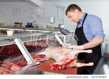Butcher preparing meat of lamb Butcher preparing meat of lamb 63379484