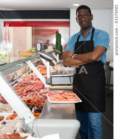 Confident owner of butcher shop Confident owner of butcher shop 63379485