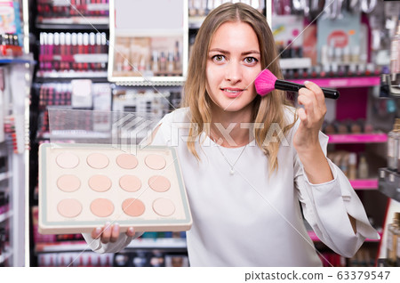 Positive woman demonstrating powder 63379547