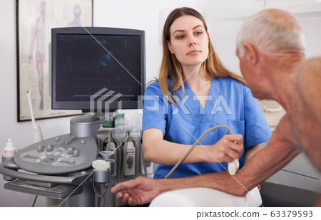 Elderly man patient undergoing examination hand Elderly man patient undergoing examination hand 63379593