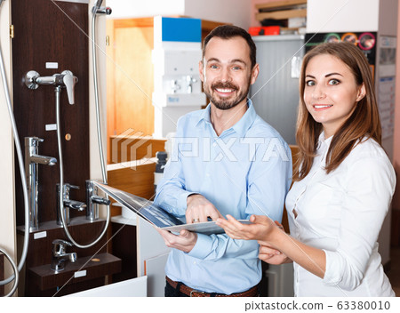 Married couple visiting furniture salon in search of shower mixer Married couple visiting furniture salon in search of shower mixer 63380010