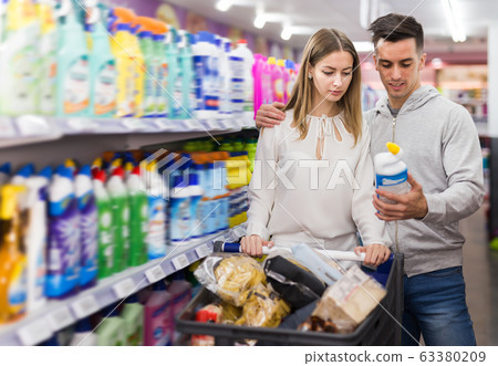 Couple choosing household detergents Couple choosing household detergents 63380209