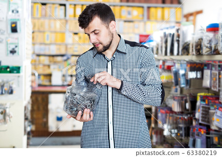 Customer examining various DIY details Customer examining various DIY details 63380219