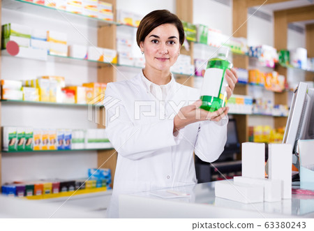 female pharmacist demonstrating assortment of pharmacy 63380243