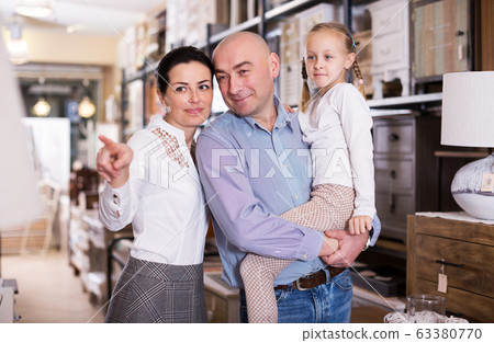 Family is choosing new furniture Family is choosing new furniture 63380770
