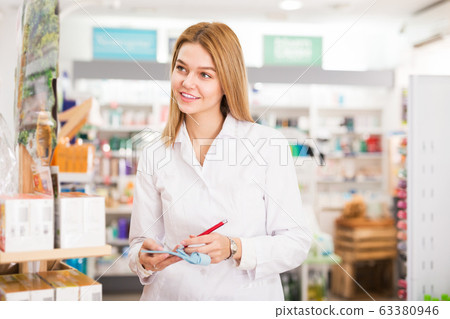 Pharmacist making notes in pharmacy Pharmacist making notes in pharmacy 63380946
