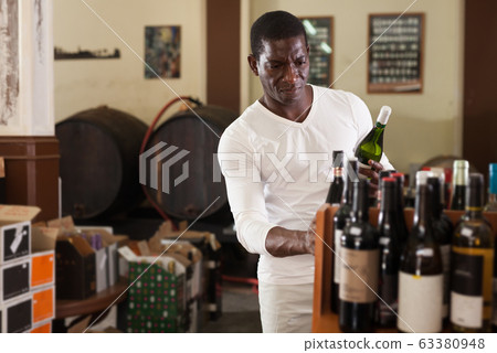 Man choosing wine in store Man choosing wine in store 63380948