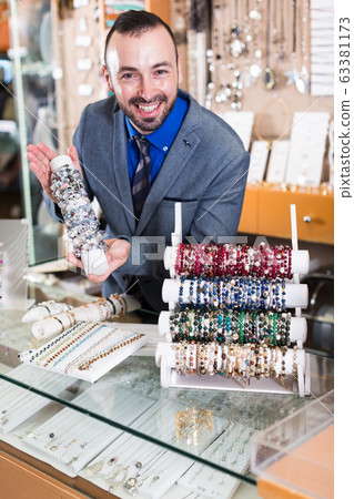 adult man worker selling bracelets adult man worker selling bracelets 63381173