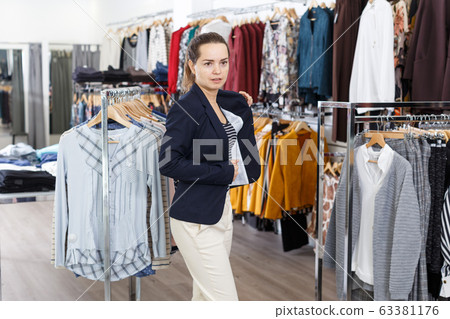 Woman trying blouse clothing boutique Woman trying blouse clothing boutique 63381176