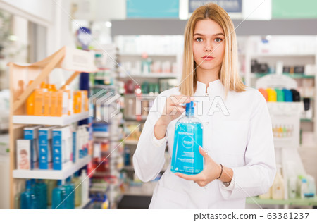 Smiling pleasant positive female druggist 63381237