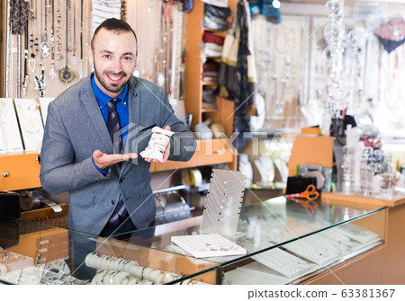 adult man worker selling bracelets adult man worker selling bracelets 63381367