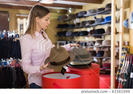 Saleswoman preparing hats in boxes for sale Saleswoman preparing hats in boxes for sale 63381899