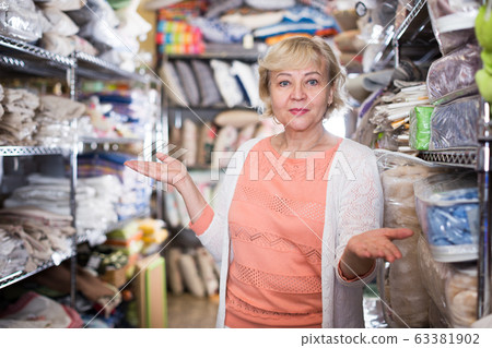 female housewife choosing textile in the store female housewife choosing textile in the store 63381902
