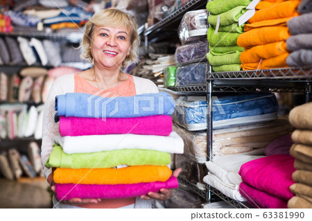 Female buyer choosing towel Female buyer choosing towel 63381990