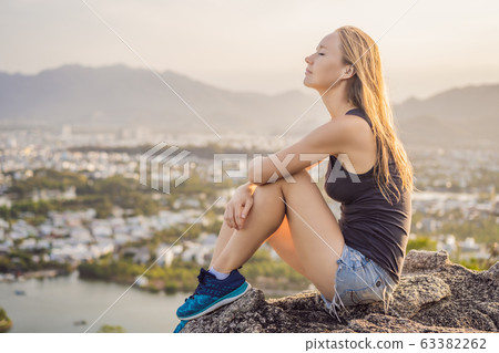 Woman tourist on the background of Nha Trang city. Travel to Vietnam Concept Woman tourist on the background of Nha Trang city. Travel to Vietnam Concept 63382262