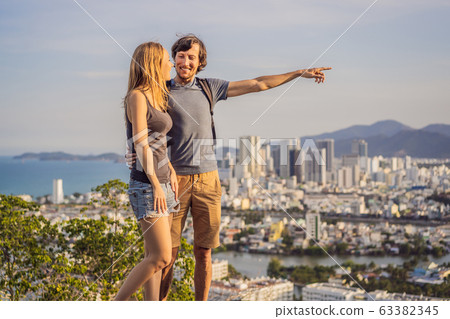 Happy couple tourists on the background of Nha Trang city. Travel to Vietnam Concept Happy couple tourists on the background of Nha Trang city. Travel to Vietnam Concept 63382345