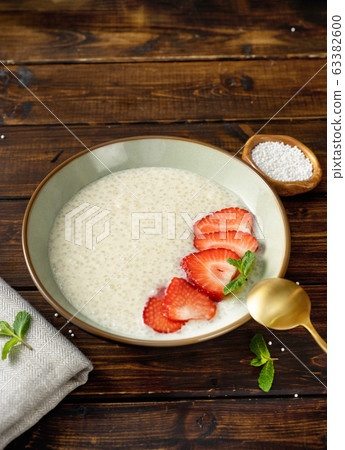 Vertical shot of delicious tapioca pudding on brown rustic background Vertical shot of delicious tapioca pudding on brown rustic background 63382600