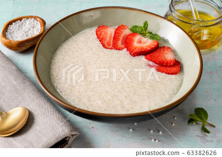Vegan tapioca pudding in a plate on light blue background 63382626