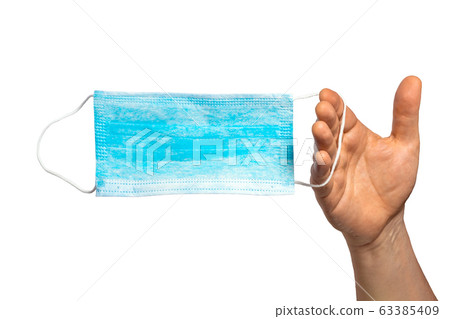Protective face mask in hand. Surgical mask. Medical mask and corona virus protection isolated on a 63385409