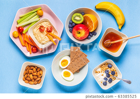 Healthy snack on a pastel background. 63385525