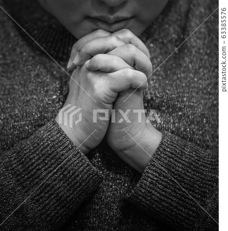 An Asian woman is praying clinging to God with what she wishes for healing An Asian woman is praying clinging to God with what she wishes for healing 63385576
