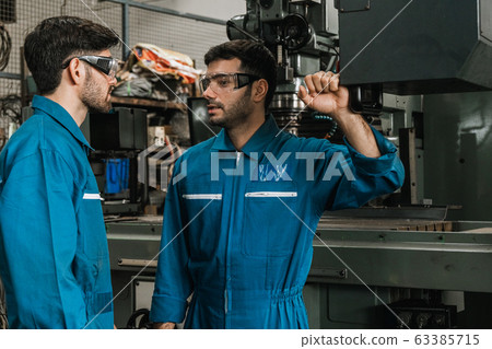 Engineer men wearing uniform safety in factory Engineer men wearing uniform safety in factory 63385715