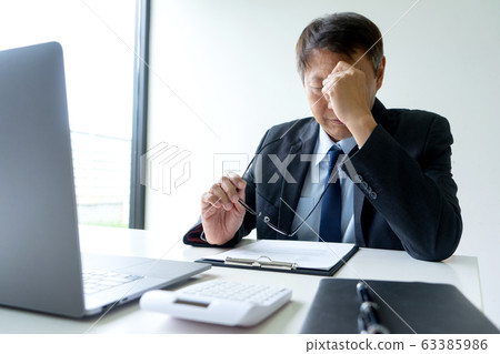 Businessman in casual style sit and feel headache Businessman in casual style sit and feel headache 63385986