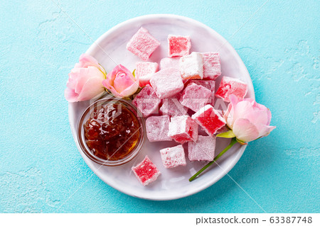Turkish delight lokum, rose flavour in a white plate. Blue background. Top view. 63387748