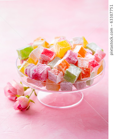 Assorted Turkish delights on glass cake stand. Pink background. Copy space. 63387751