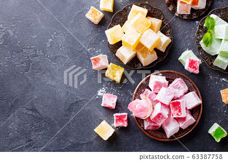 Assortment of Turkish delights. Dark background. Copy space. Top view. Assortment of Turkish delights. Dark background. Copy space. Top view. 63387758