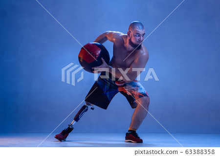 Athlete disabled amputee isolated on blue studio background Athlete disabled amputee isolated on blue studio background 63388358