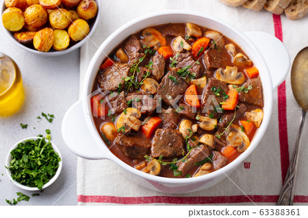 Beef bourguignon stew with vegetables. Close up. Top view. Beef bourguignon stew with vegetables. Close up. Top view. 63388361